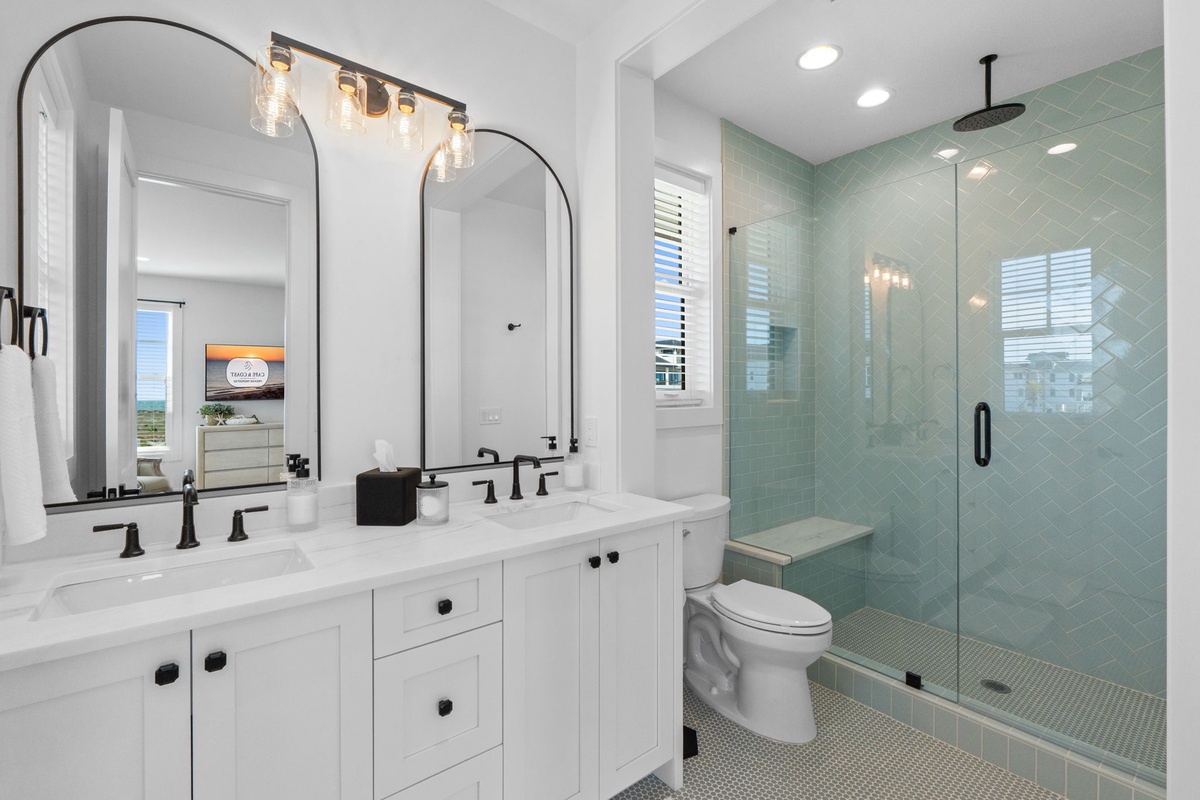 Refresh in your spa-inspired bathroom with elegant dual vanities, rainfall shower, and soothing mint tile that creates a peaceful retreat.