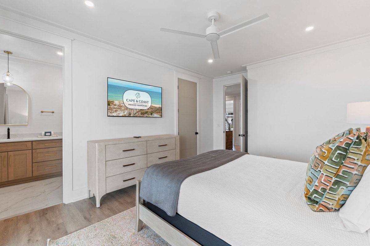 Your spacious bedroom sanctuary features crisp linens, modern furnishings, and a ceiling fan to keep you comfortable year-round.