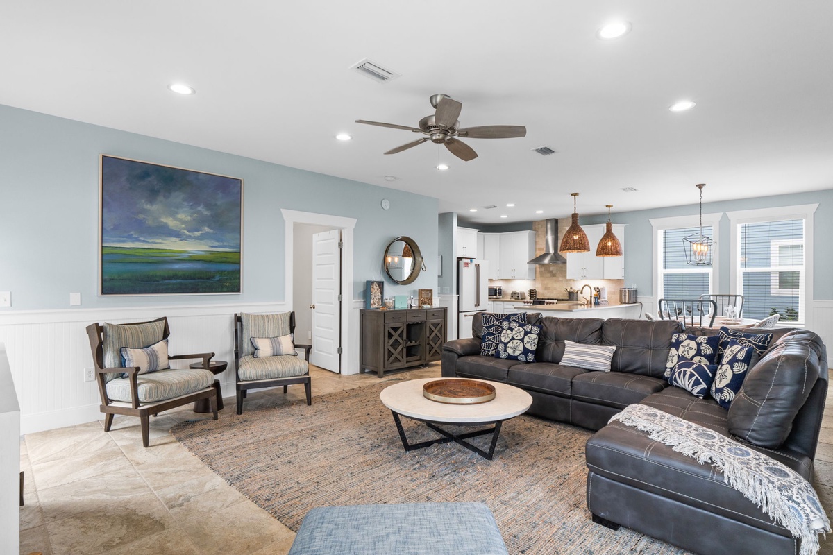 Unwind in your spacious living area with plush seating, coastal accents, and an open flow into a fully-equipped kitchen—perfect for gathering and creating vacation memories.