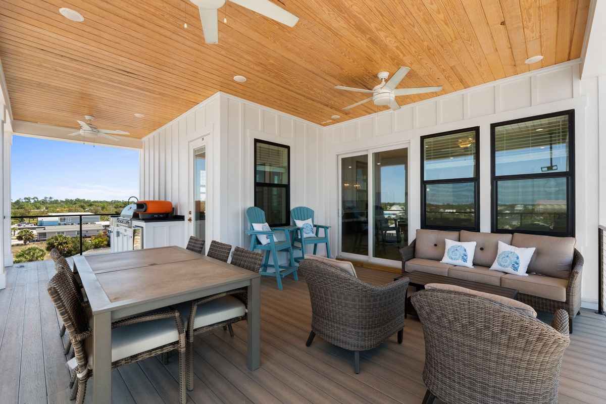 Step onto your private terrace where coastal breezes flow through this beautifully appointed outdoor living space.