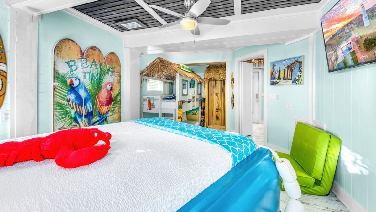 Sleep in style with this unique truck bed surrounded by tropical beach vibes and colorful parrot art.