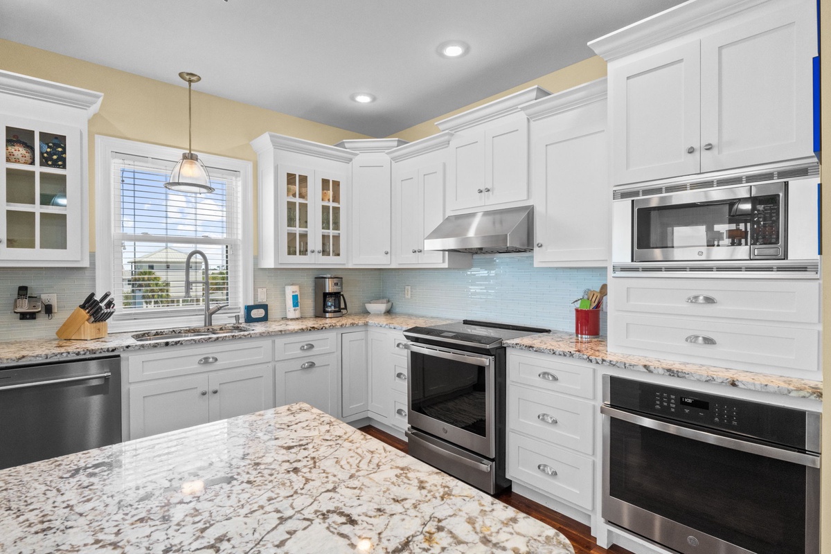 Bright and welcoming, your fully equipped kitchen features granite countertops, stainless appliances, and plenty of space to prepare meals together during your stay.