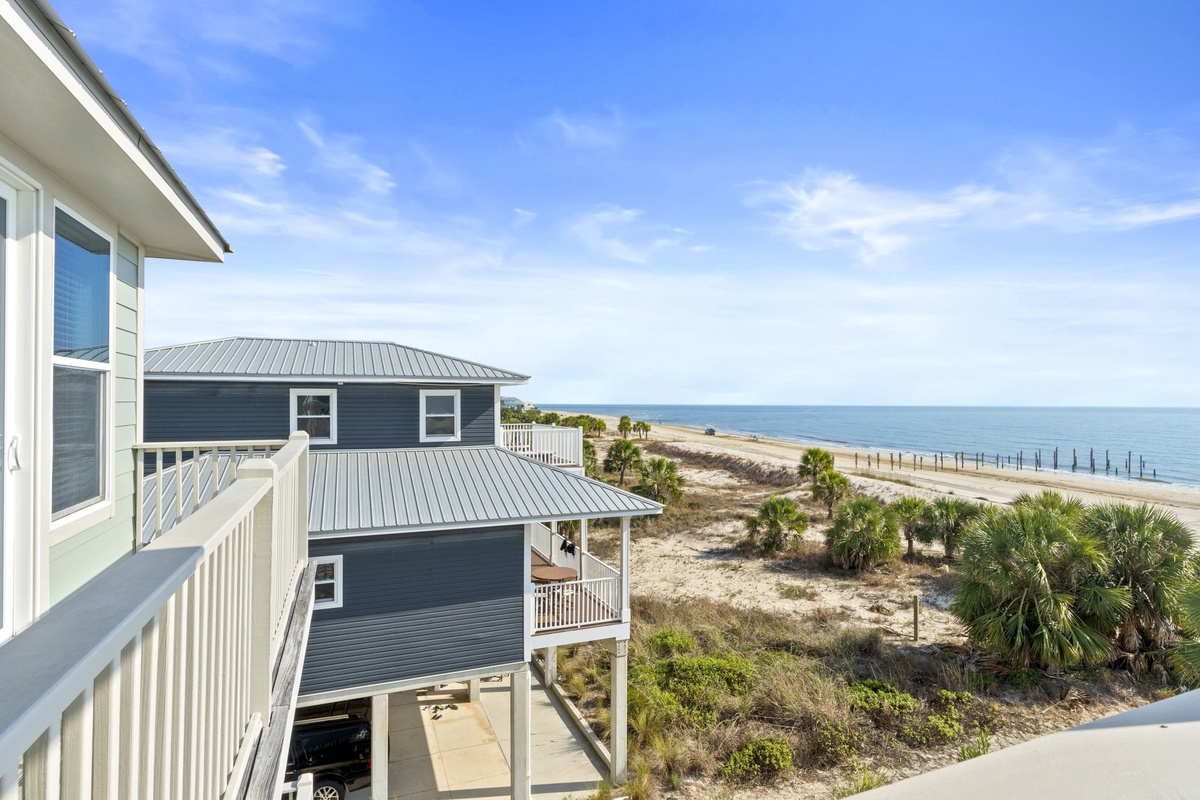 Coastal property with stunning beachfront views and nearby vacation homes creates the perfect seaside getaway location.