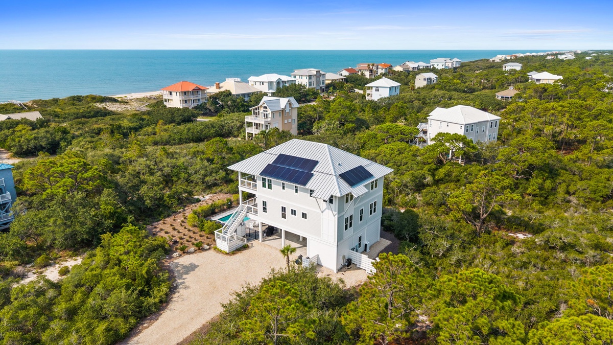 This coastal retreat sits nestled among native greenery just moments from pristine beaches, offering a private pool and solar-powered comfort in a peaceful neighborhood setting.
