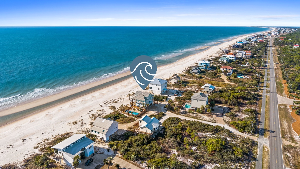 Stunning beachfront location with pristine white sand and turquoise waters stretching endlessly along the coast.