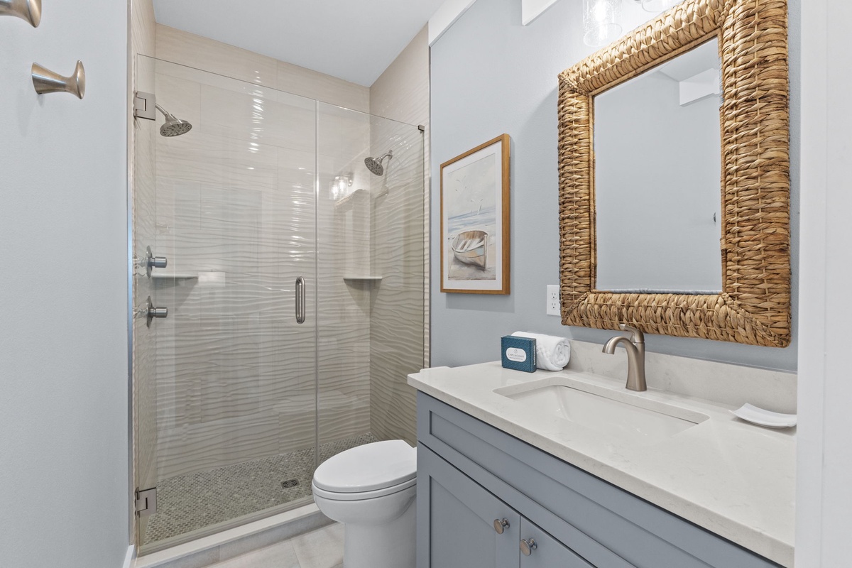 Freshen up in your private bathroom with a relaxing walk-in shower, coastal-inspired details, and plenty of natural light to start your day.