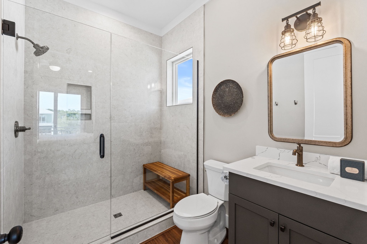 Step into your spa-like bathroom with a spacious glass shower, elegant vanity, and warm lighting that creates the perfect retreat.