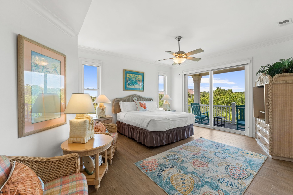 Wake up to soft coastal breezes and lush greenery framed by your private balcony doors. This airy bedroom invites you to unwind in comfort with warm beach-inspired décor and peaceful views.