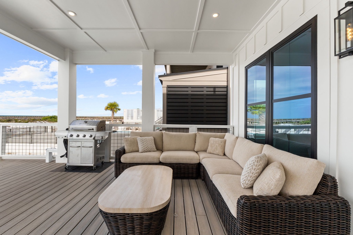 Your private outdoor retreat features plush seating and BBQ grill with stunning water views for memorable evenings.
