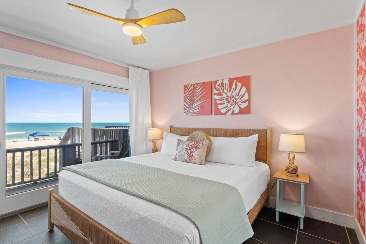 Wake up to stunning ocean views from your private balcony. This beachy bedroom features coastal décor, a comfy bed with crisp linens, and a ceiling fan to keep you cool on sunny days.