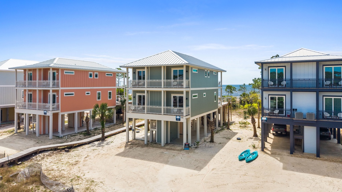 Colorful beachfront homes elevated on stilts create a vibrant coastal community perfect for your seaside getaway.
