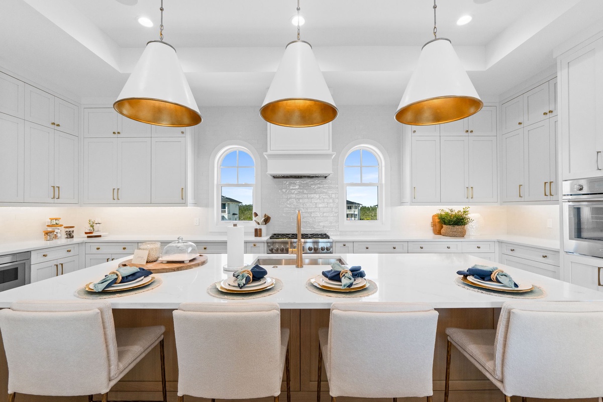 Your gourmet kitchen awaits with gleaming countertops, statement pendant lights, and everything you need to create memorable meals together.