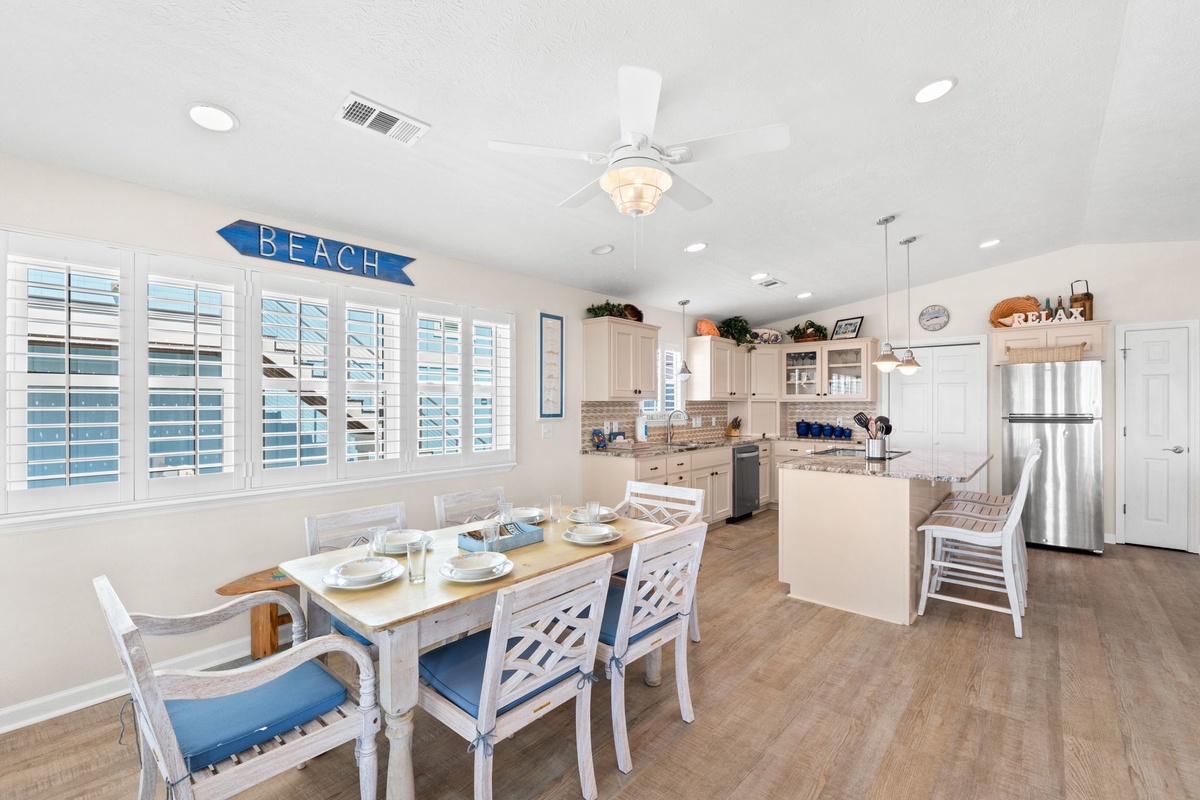 Gather around this bright coastal dining space where beach vibes meet culinary comfort. Your seaside getaway begins here.