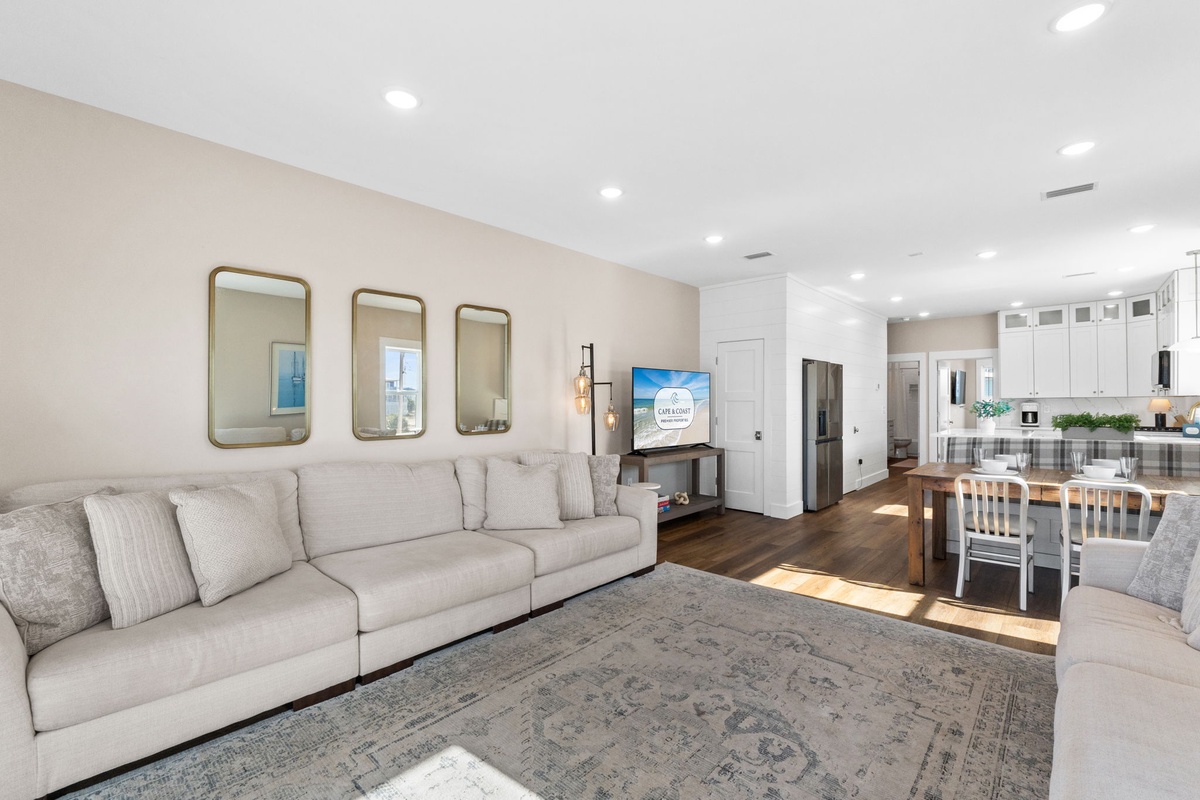 Relax in your spacious open-concept living room, where modern comfort meets elegant design with plush seating and seamless flow to the gourmet kitchen.