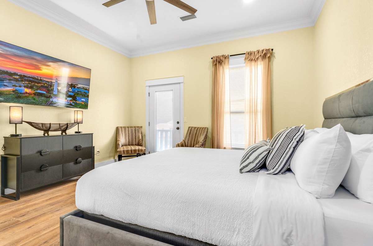 Sink into plush bedding in your elegantly appointed bedroom, where warm tones and stylish furnishings create the perfect retreat.