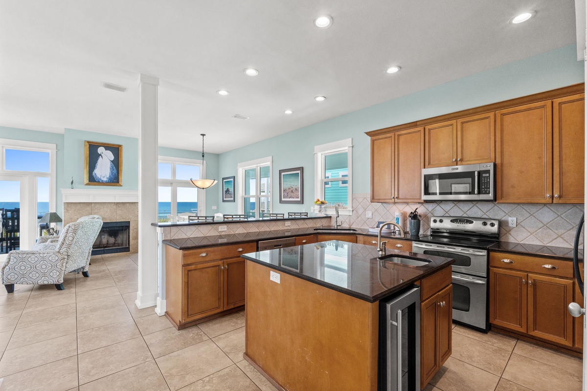 Your gourmet kitchen awaits with granite counters, ocean views through expansive windows, and everything needed to create memorable meals.