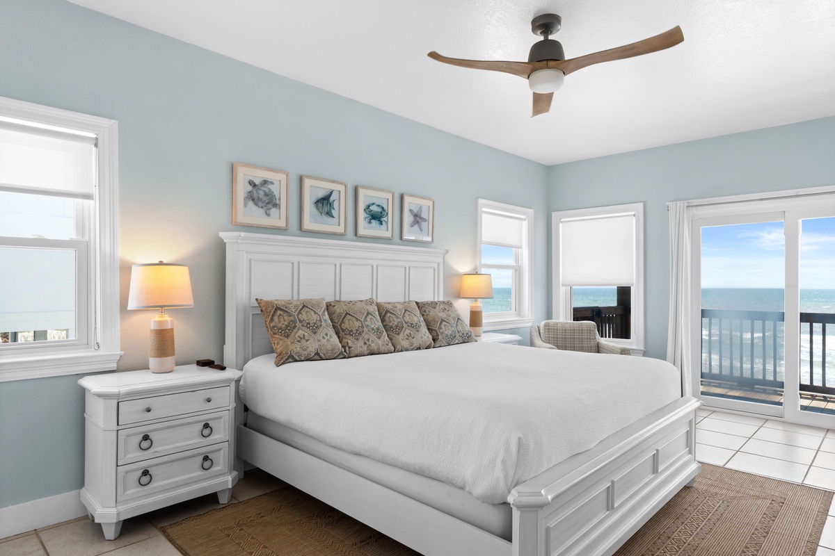 Wake up to stunning ocean vistas from your cozy bed. Soft coastal blues and crisp linens create your perfect beach retreat.