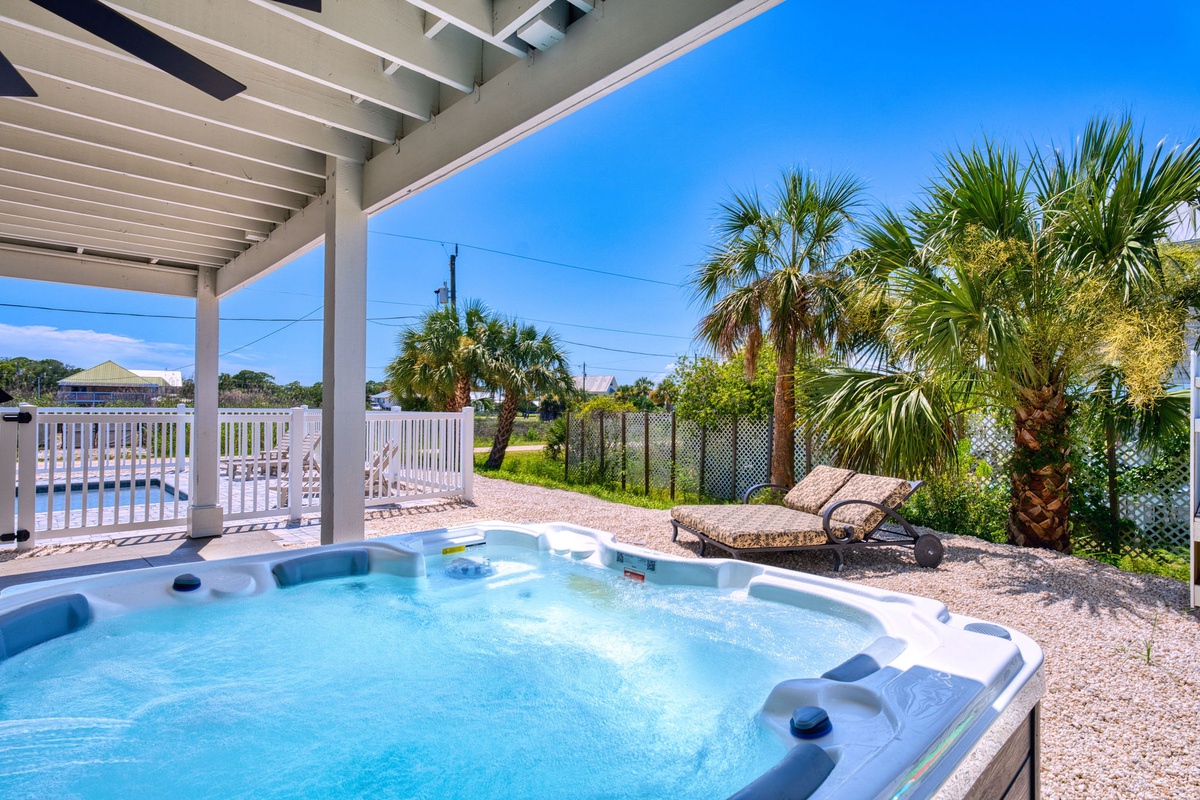 Slip into warm bubbling water beneath swaying palms, where your private hot tub invites ultimate relaxation under endless blue skies and tropical breezes.