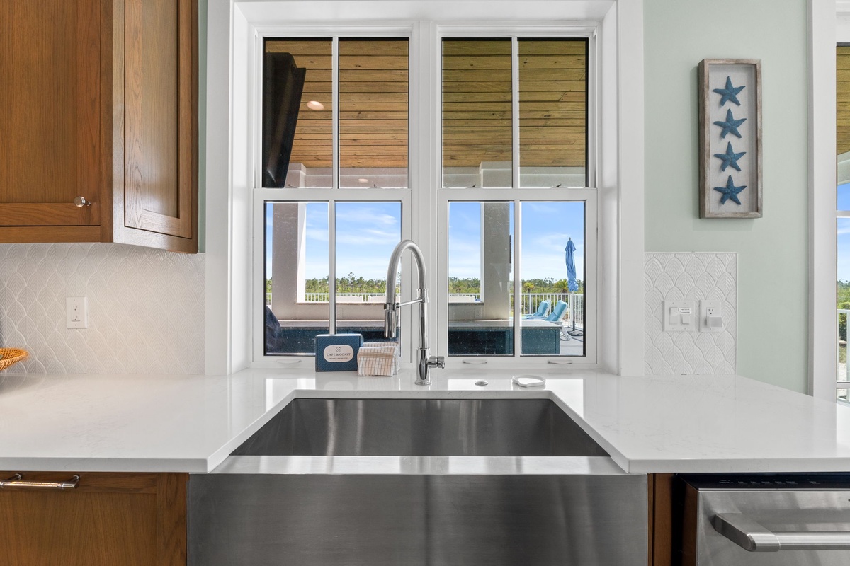Sleek stainless steel sink and gleaming counters invite you to whip up a meal while gazing out at your private deck and the open skies beyond.