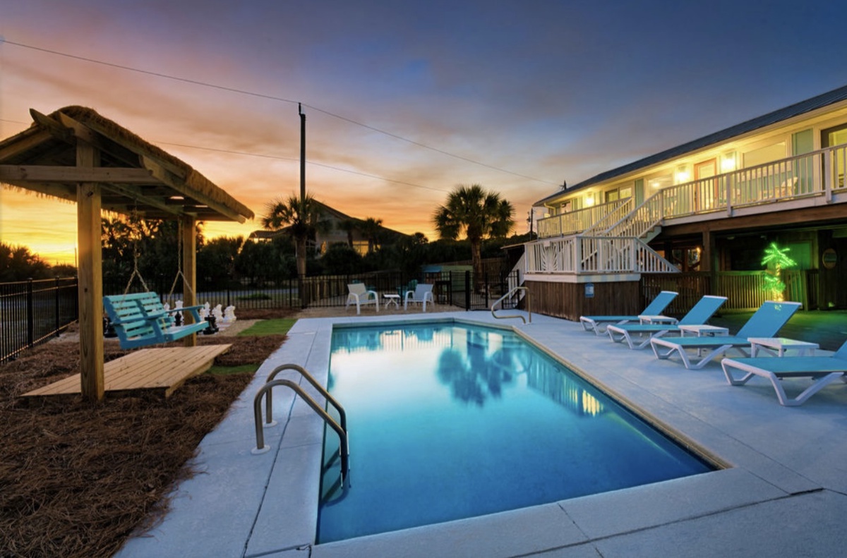 As the sun sets, the pool area transforms into a peaceful space for evening swims and unwinding.