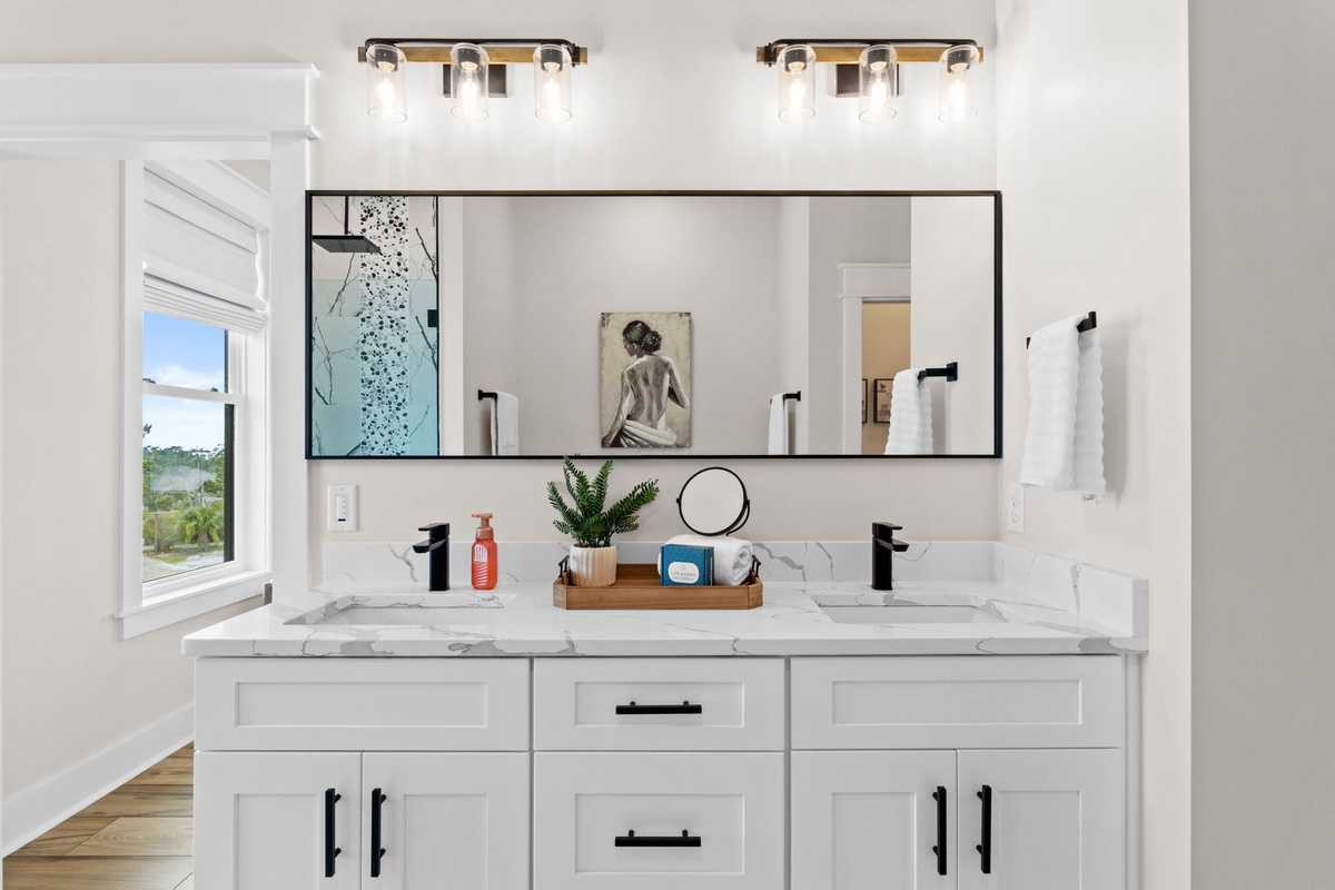 Step into your modern bathroom featuring dual sinks, sleek marble countertops, stylish black fixtures, and contemporary lighting that creates a spa-like atmosphere for your morning routine.