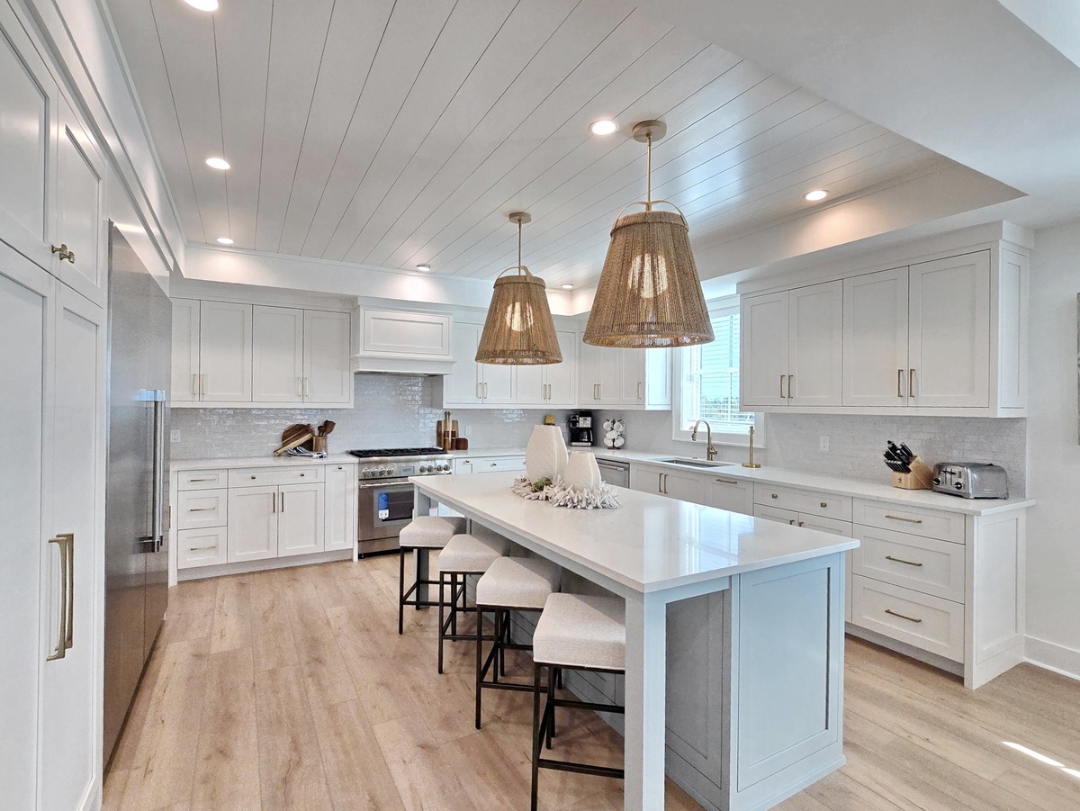 Your gourmet kitchen awaits with gleaming countertops, professional appliances, and a spacious island perfect for cooking together.