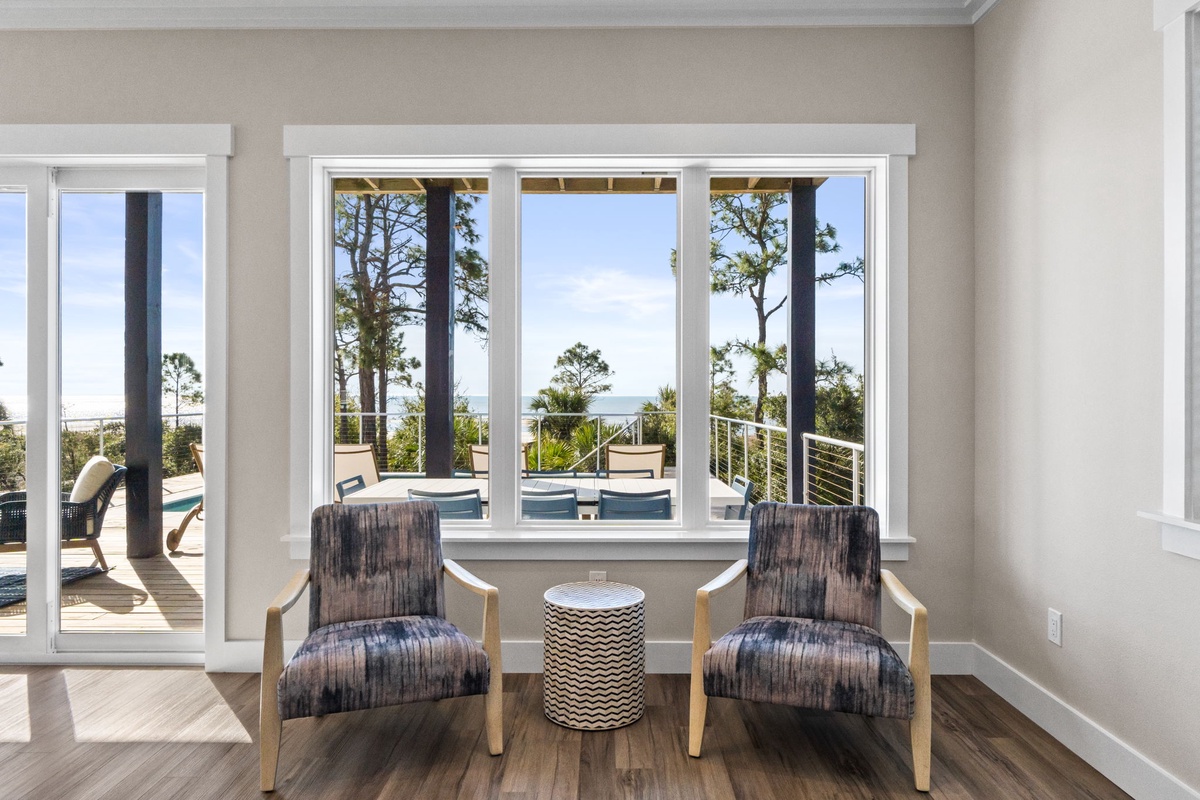 Sink into comfortable chairs while gazing through floor-to-ceiling windows at your private pool and ocean beyond.