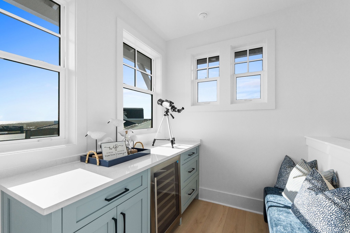 Your bright study nook features gorgeous windows, built-in storage, and a cozy reading corner perfect for stargazing or planning adventures.