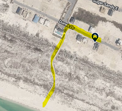 Aerial view shows the property's location along the pristine coastline with beach access.