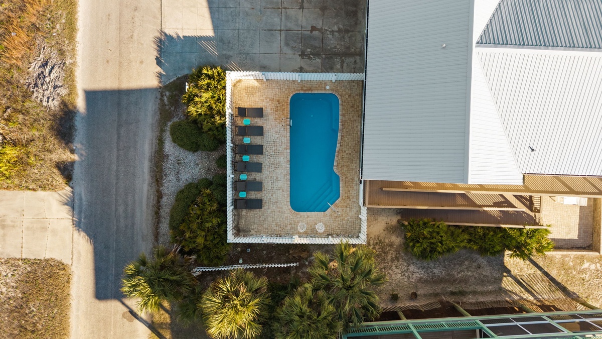 Modern property with pool area, surrounded by tropical landscaping and outdoor amenities.