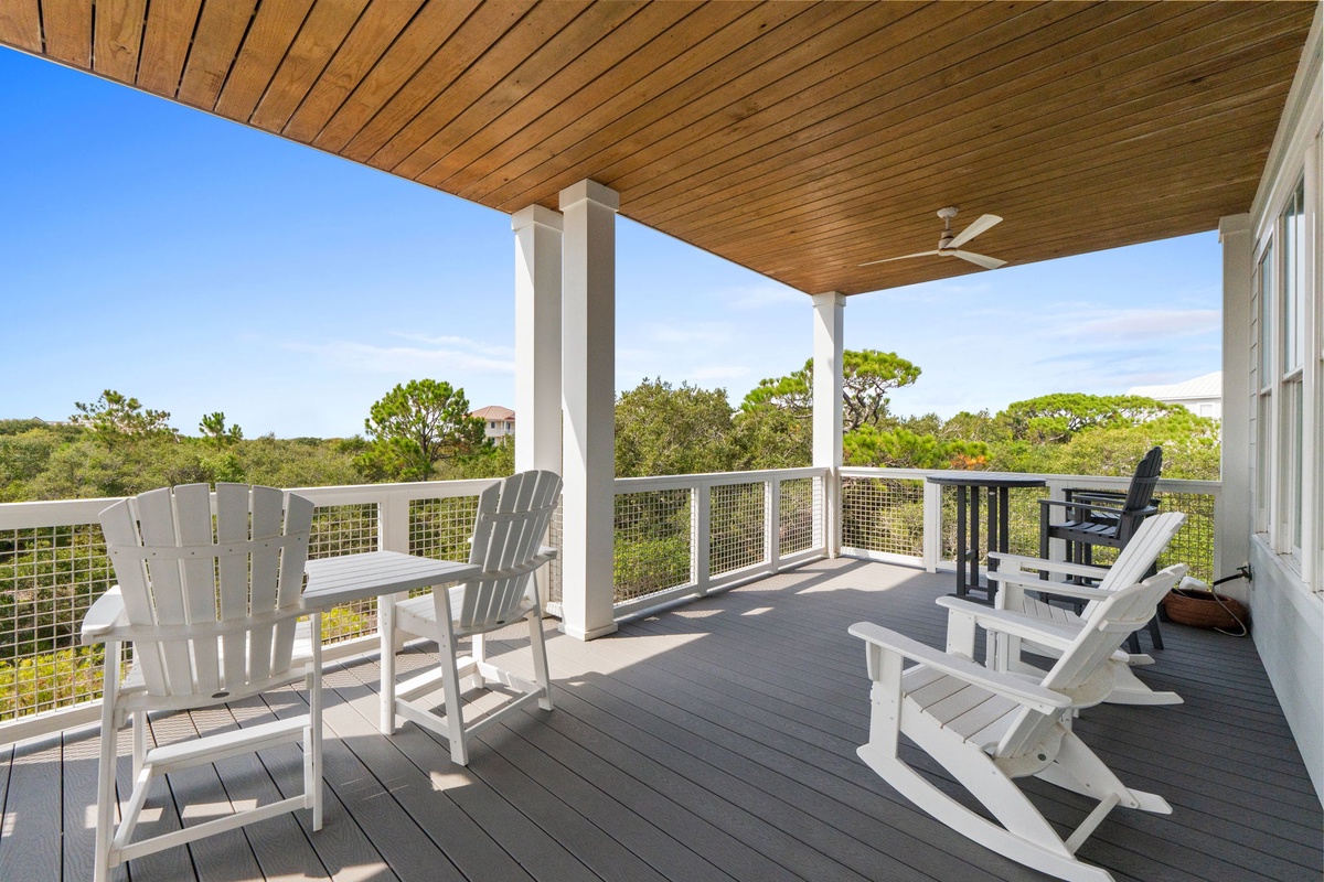 Picture yourself unwinding on your private covered deck, gently rocking in an Adirondack chair as you gaze out over lush coastal greenery and open skies.