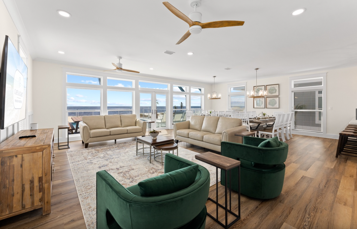 Sink into plush seating while ocean views frame your perfect getaway through floor-to-ceiling windows in this bright, airy space.