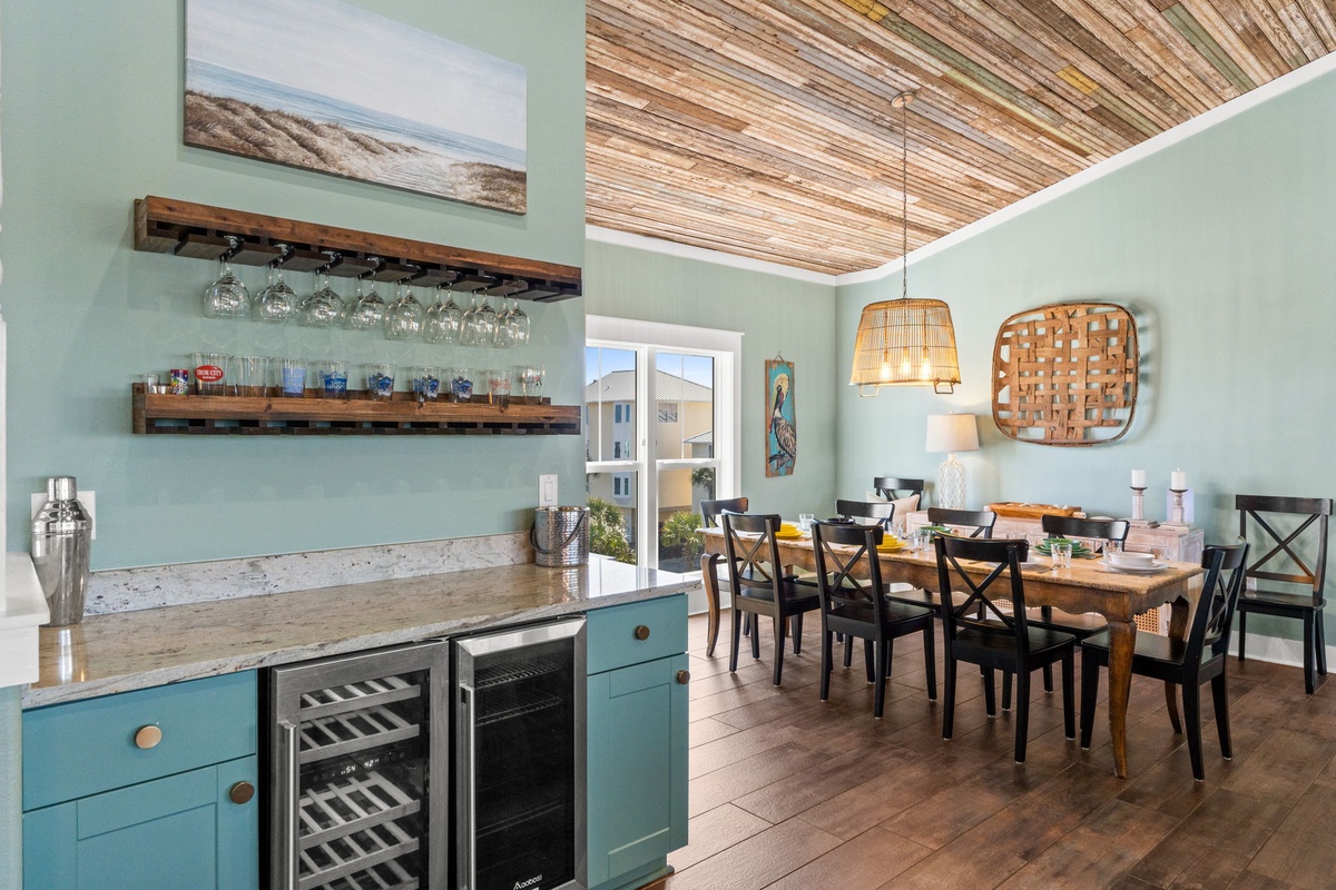 Gather around your stylish dining table beneath the stunning wood-slat ceiling, with coastal art and a well-stocked bar area nearby.