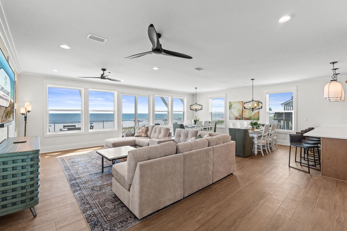 Sink into plush seating as ocean breezes and panoramic water views fill your bright, spacious living space—a tranquil coastal retreat with room for everyone to relax.