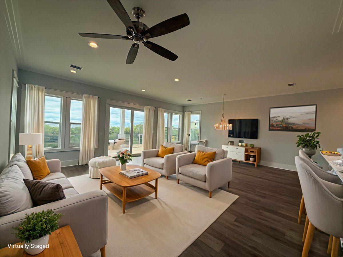 Relax in this bright living room with panoramic windows and a cooling ceiling fan overhead.