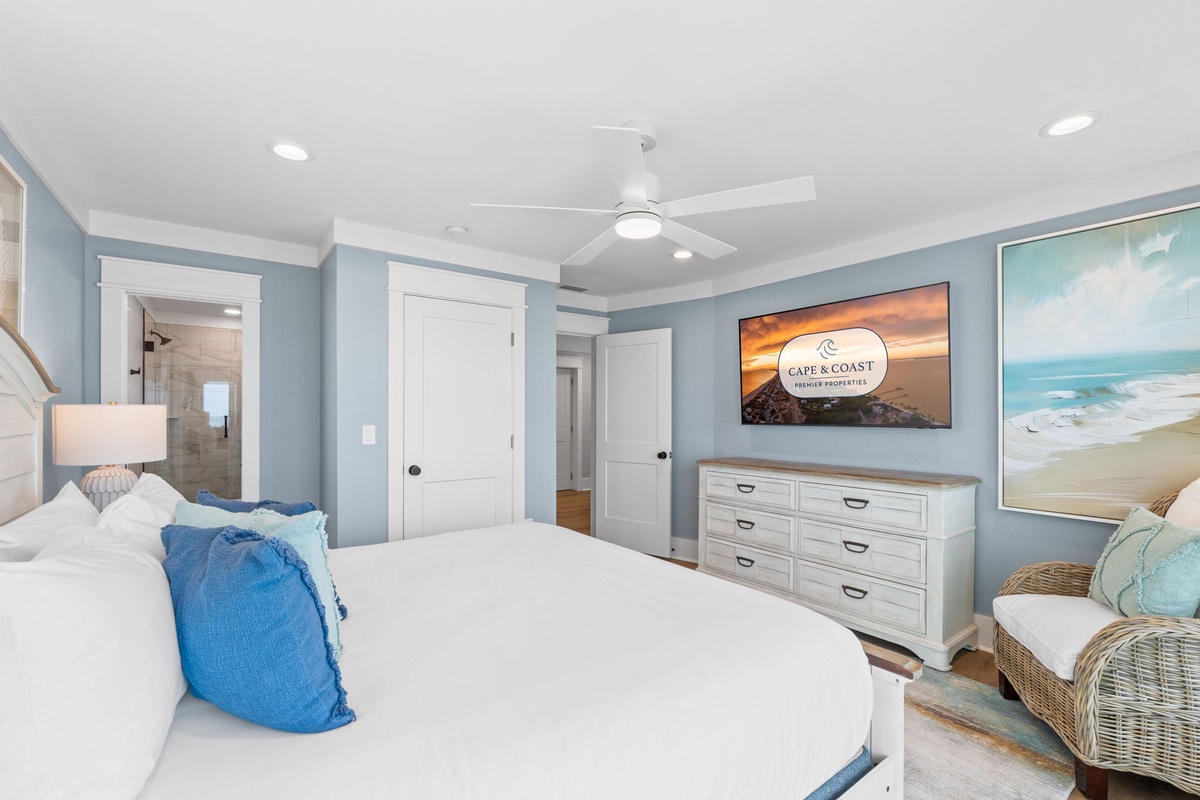 Unwind in your serene bedroom with soft blue tones and coastal decor. Plush bedding invites restful sleep, while a private ensuite awaits your morning routine.