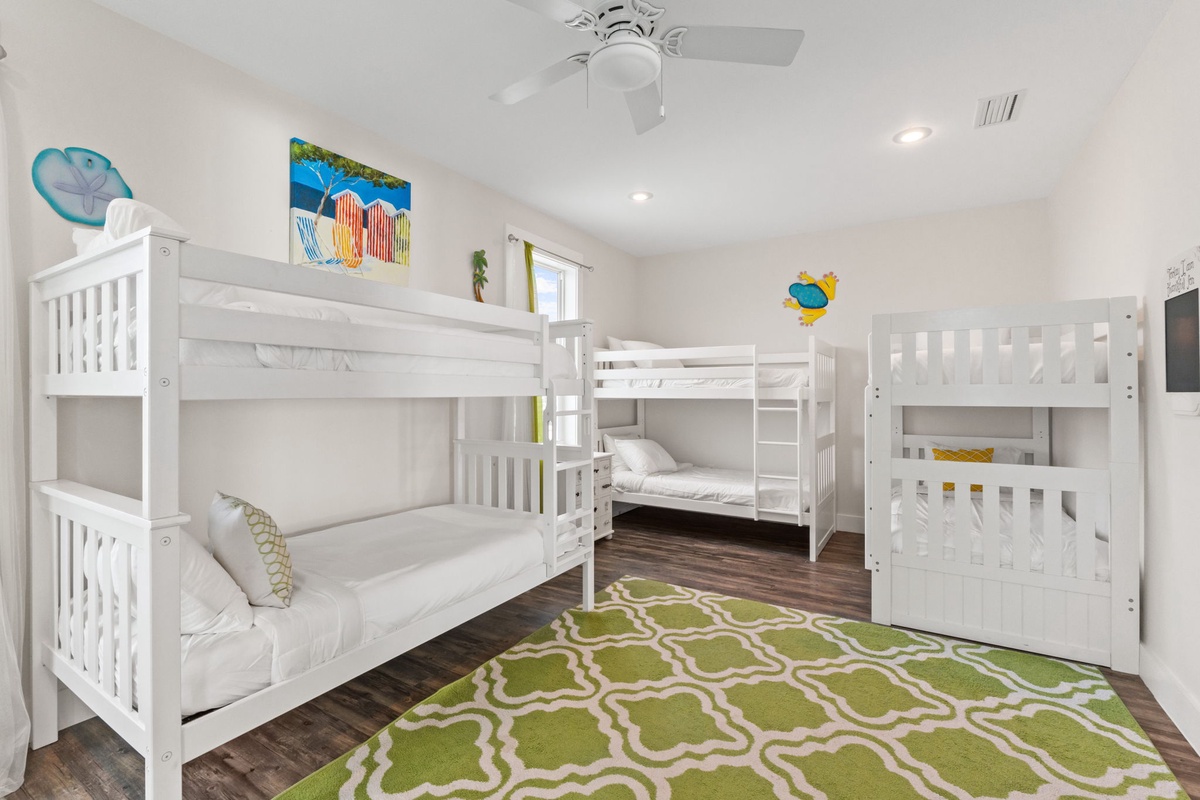 Cozy bunk room where kids can drift off to playful dreams, complete with cheerful beach artwork and soft linens.