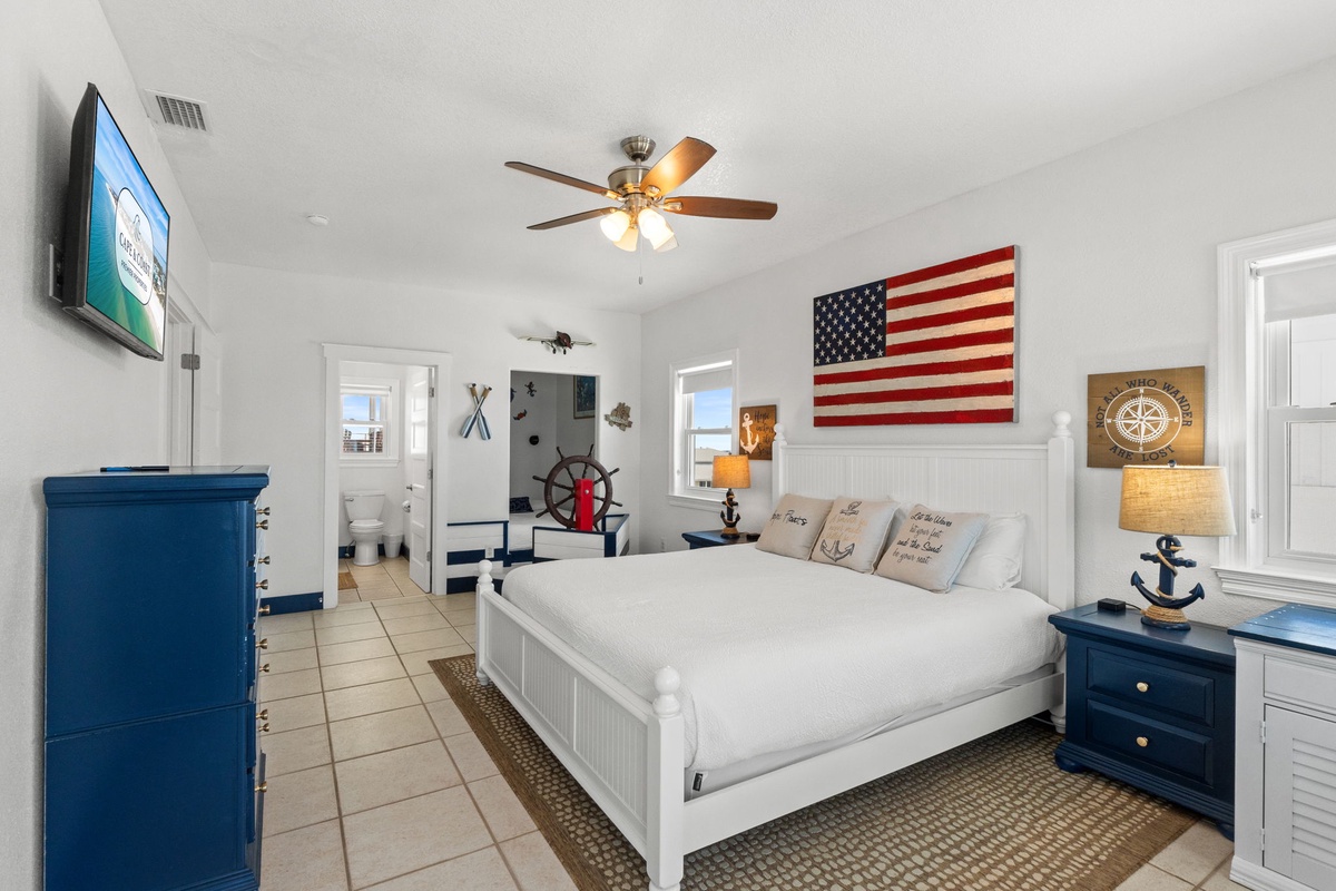 Drift off in your cozy nautical retreat, where maritime charm meets modern comfort. Crisp linens, a gentle ceiling fan, and serene beach-themed touches create your perfect coastal sanctuary.