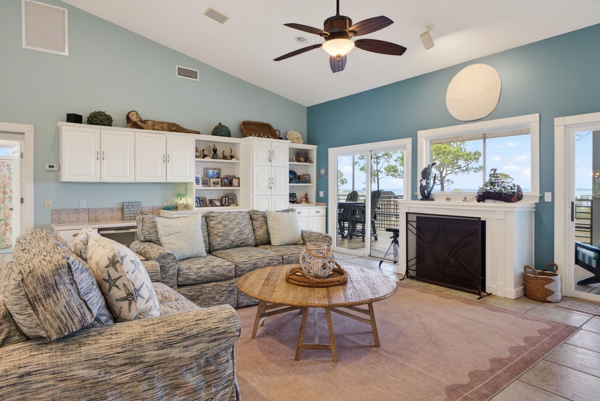 Relax in this coastal-inspired living space where ocean breezes flow through while you unwind by the fireplace.
