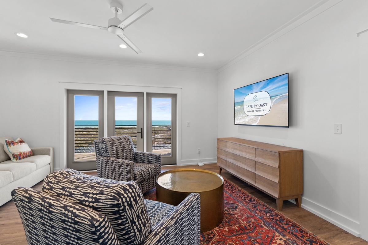 Relax in your stylish living room while enjoying stunning ocean views through floor-to-ceiling windows that frame the coastline perfectly.