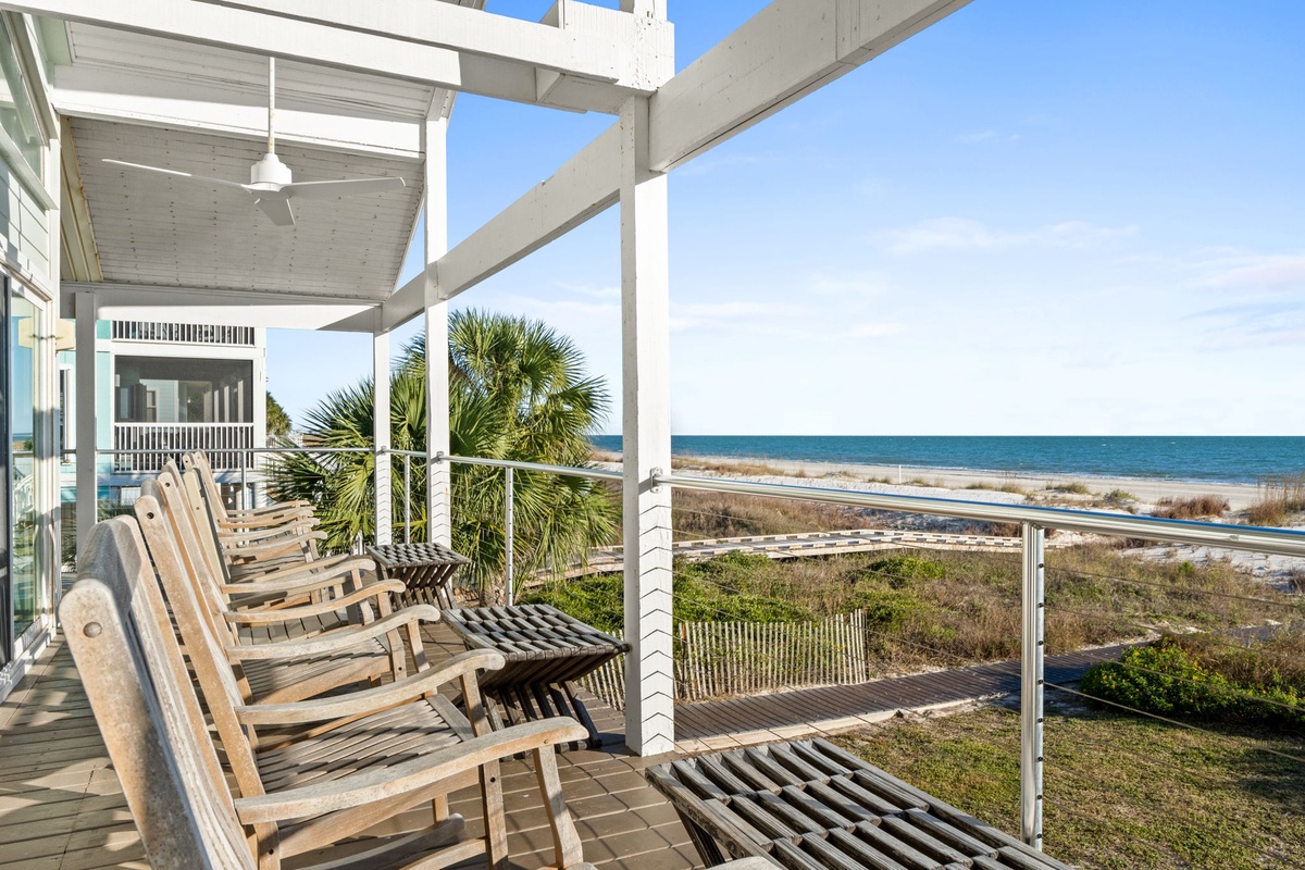 Relax on your private oceanfront deck with comfortable lounge chairs and stunning sea views stretching to the horizon.