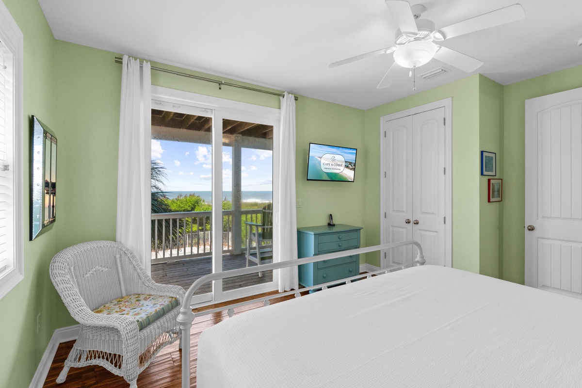 Wake up to a serene coastal escape in this light-filled bedroom. Step onto your private balcony for morning coffee and fresh sea breezes, while the cheerful decor and comfortable bed invite you to relax completely.