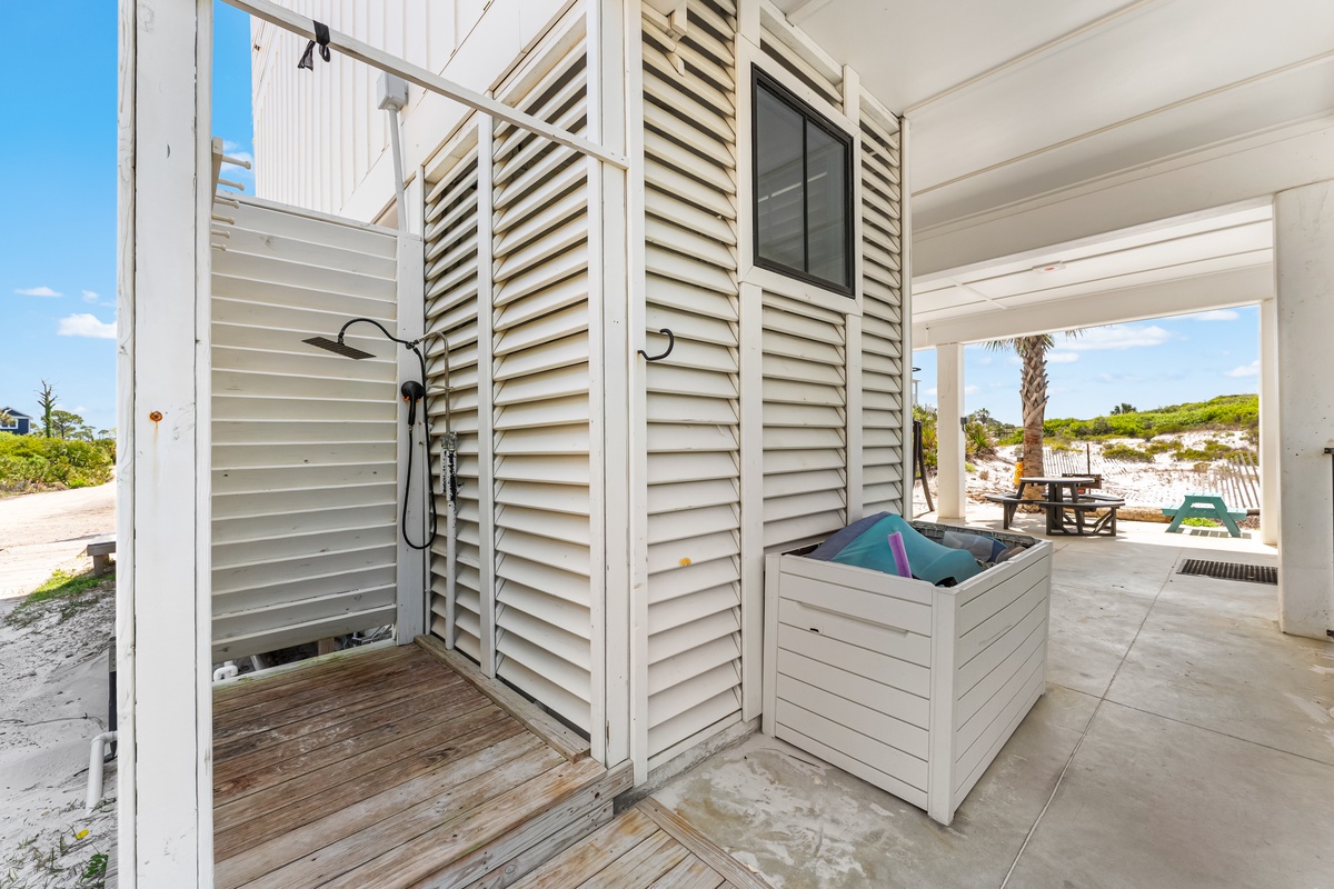 Rinse off salt and sand in your private outdoor shower, then enjoy stunning beachfront views from this coastal paradise.