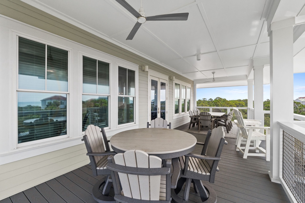 Gather around your private dining table on this spacious covered deck, where ceiling fans keep you comfortable and views of the lush tree line create the perfect backdrop for meals and conversations.