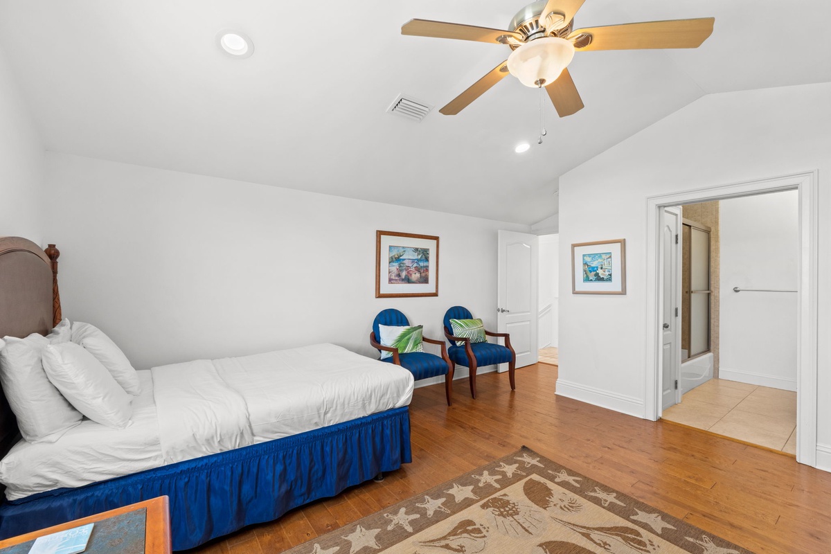Unwind in your bright, airy bedroom with vaulted ceilings, a plush bed, and a cozy sitting nook. Hardwood floors and charming coastal art complete this peaceful retreat.