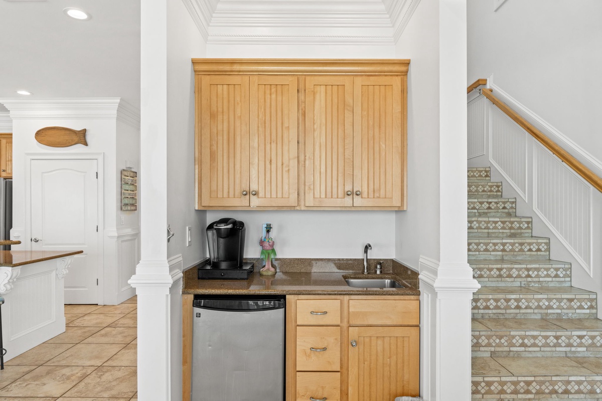 Your own mini-kitchen nook with a coffee maker, sink, and mini fridge keeps refreshments close, whether you're brewing morning coffee or chilling drinks after a beach day.