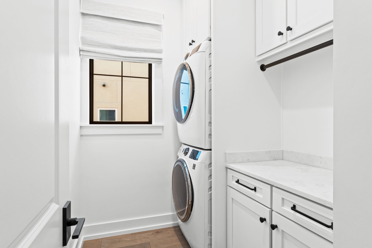 Your private laundry room features stackable washer and dryer, marble countertops, and ample storage for effortless clothing care during your stay.