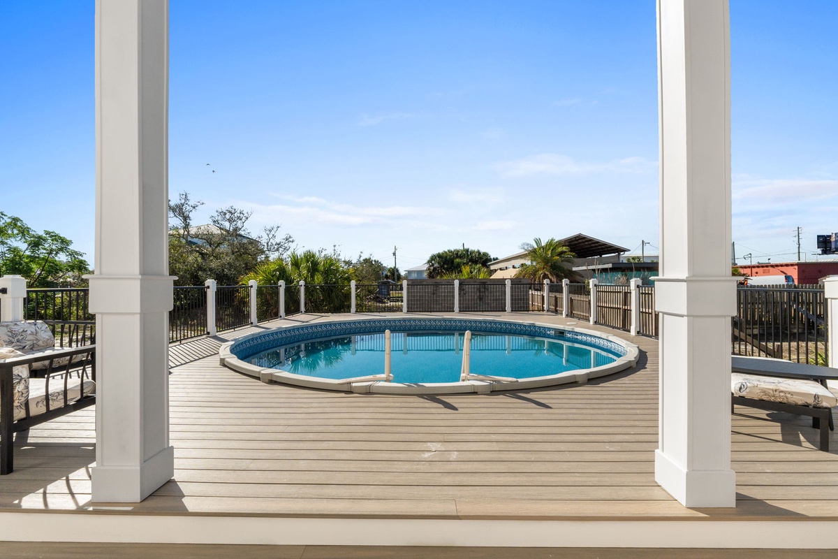 Step onto your private deck where a sparkling round pool awaits, framed by crisp white columns and surrounded by tropical views.