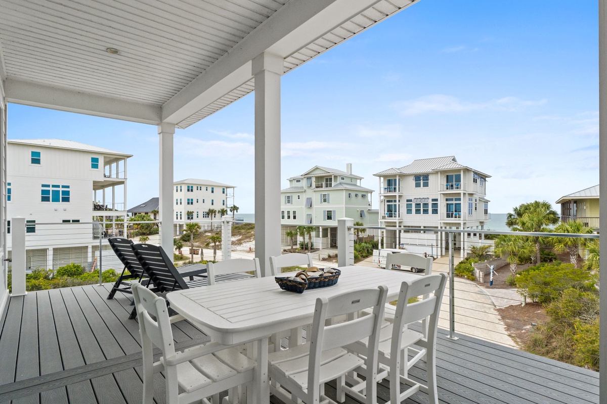 Relax at your private dining table while soaking in stunning coastal views and ocean breezes from this peaceful covered deck.