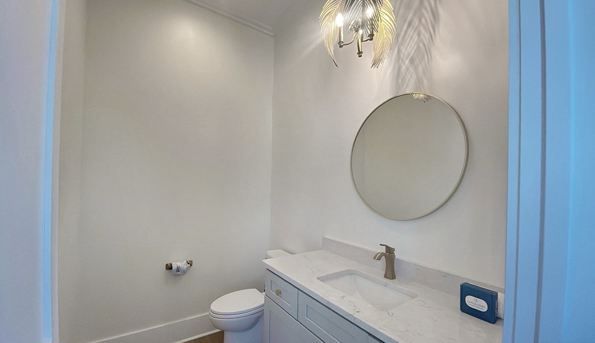 Step into your sleek, modern bathroom with chic lighting, marble countertops, and a spacious vanity designed for your comfort and convenience.